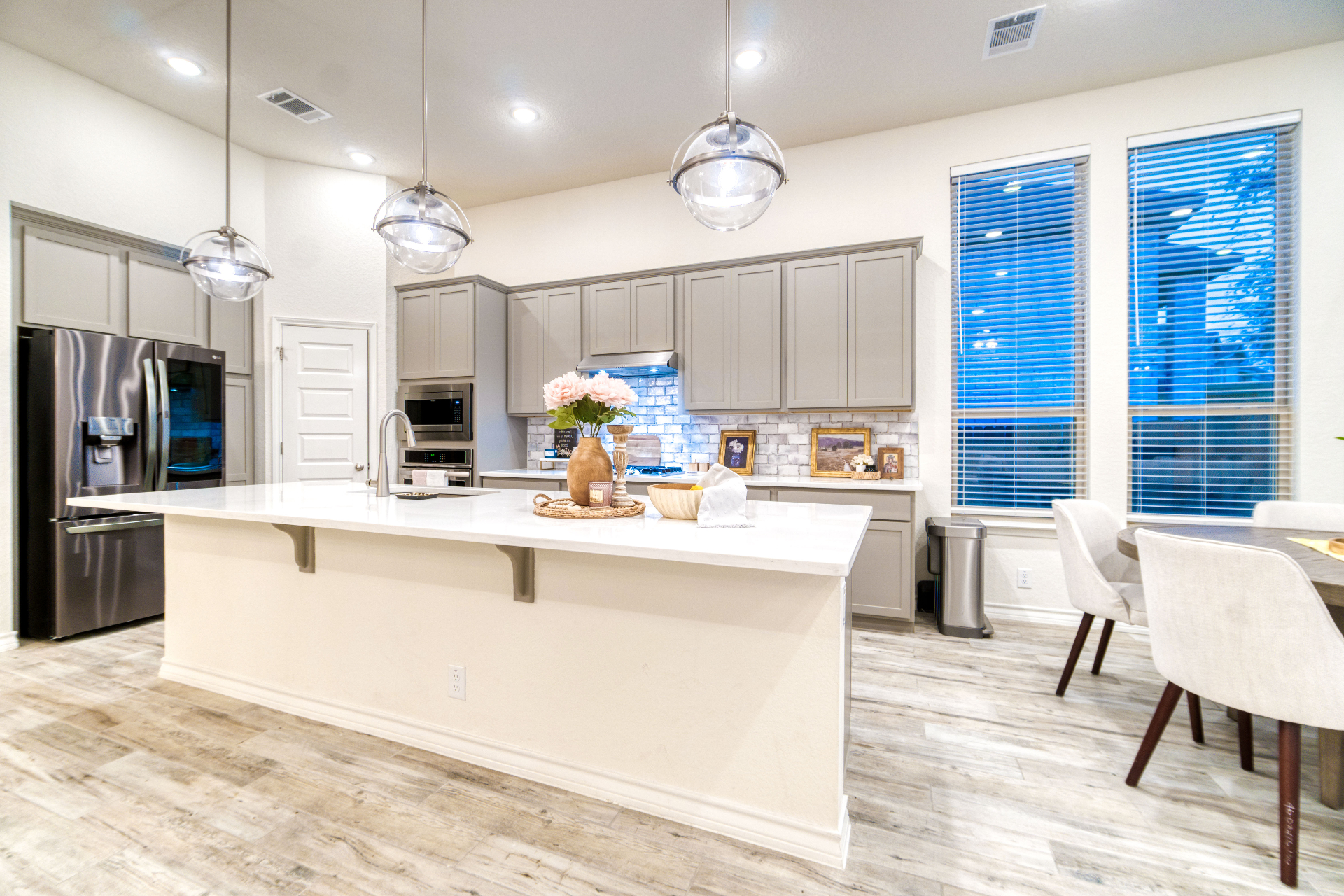 Wide view of modern kitchen with dining area